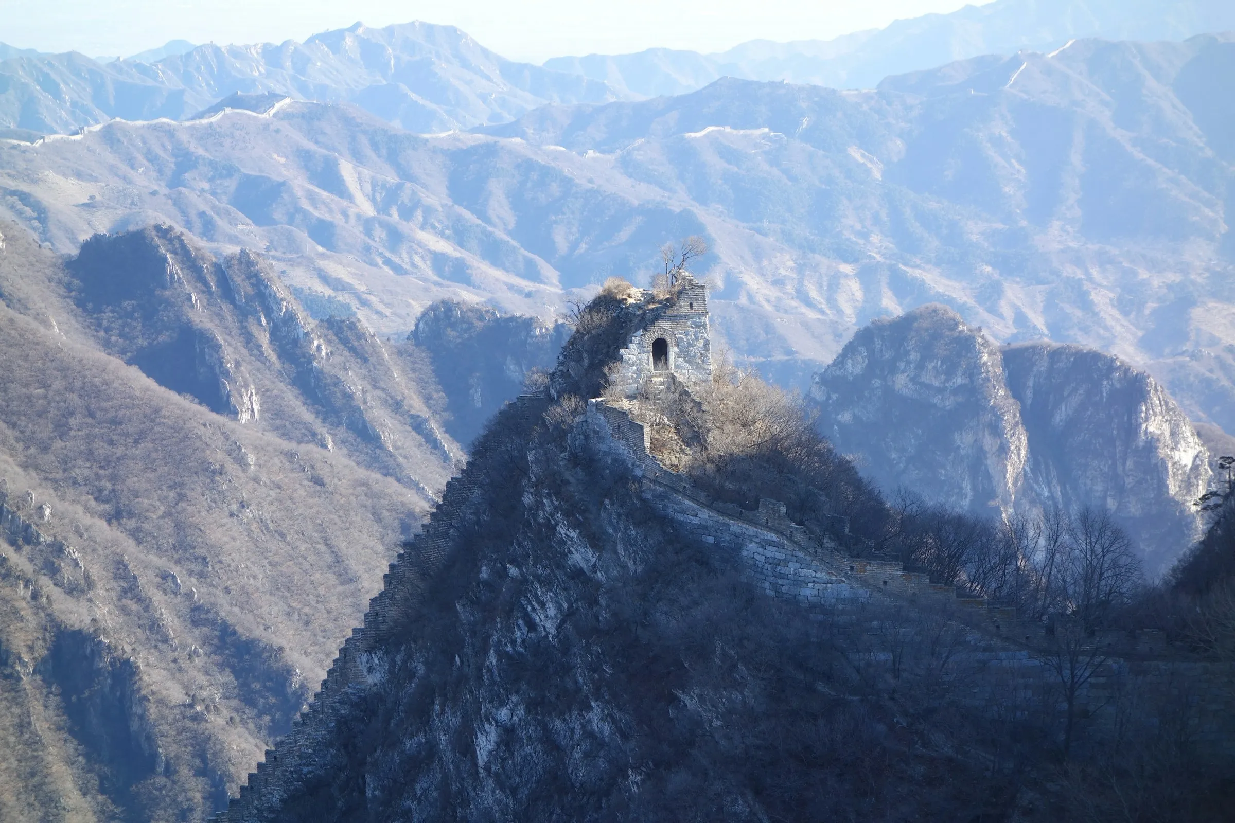 A ruined watchtower on a sheer rocky peak on an unrestored stretch of the Great Wall